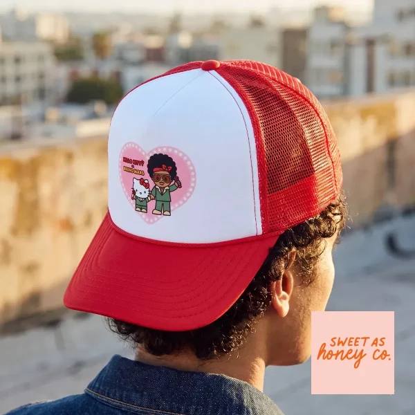 Hello Kitty and Bruno Mars The Romantic Tour 2026 Trucker Hat Merch 2 Front view of a red and white trucker hat featuring a Hello Kitty and Bruno Mars Romantic Tour 2026 print. (Detail view #3)