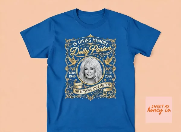 Dolly Parton Death In Loving Memory T-Shirt 1946 2026 1 Front view of a black Dolly Parton memorial T-shirt with gold filigree and portrait graphic. (Detail view #2)