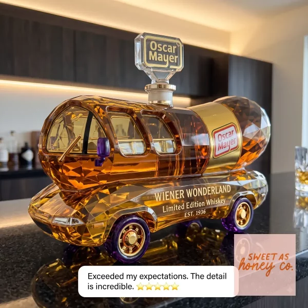 Oscar Mayer Wiener Wonderland Glass Whiskey Decanter Limited Edition 2 Oscar Mayer Wienermobile shaped whiskey decanter in amber crystal on a desk. (Detail view #3)